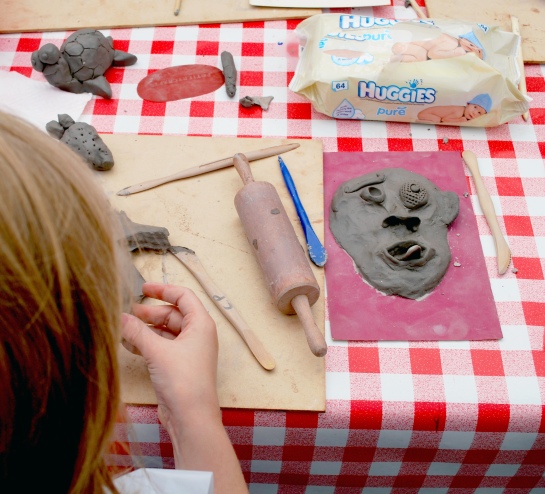A clay face materialises out of the table...